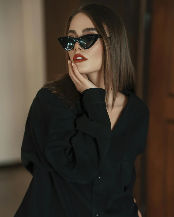 a young woman posing with shades on