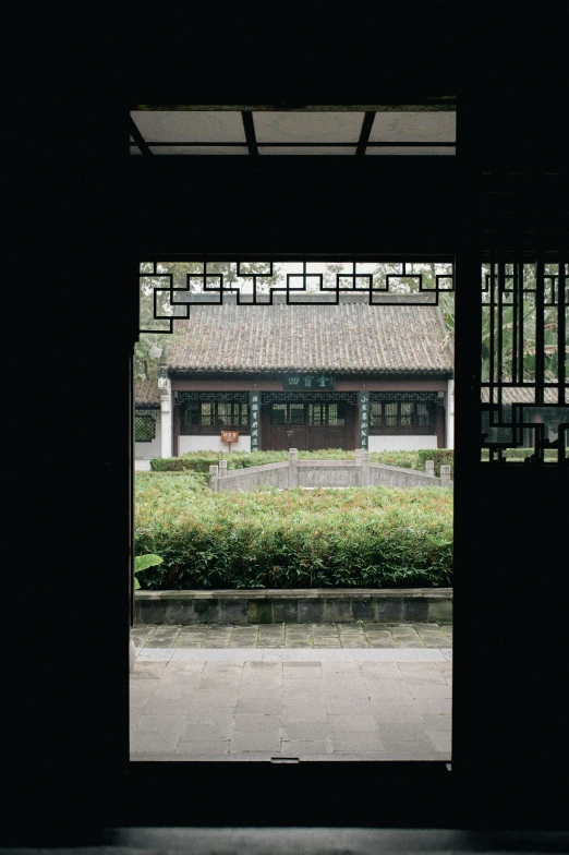 a window opened to an outside courtyard with a clock