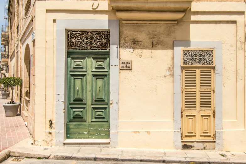 the old yellow building is painted a deep green color