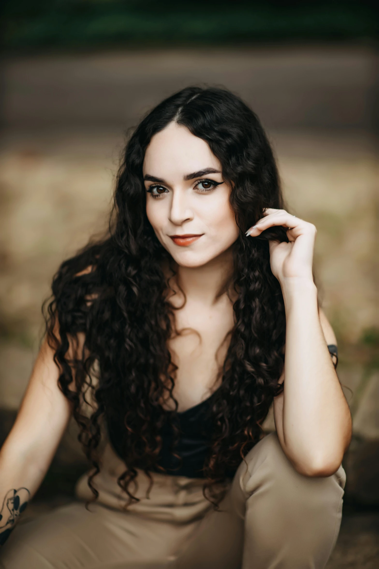 a young woman with long curly black hair