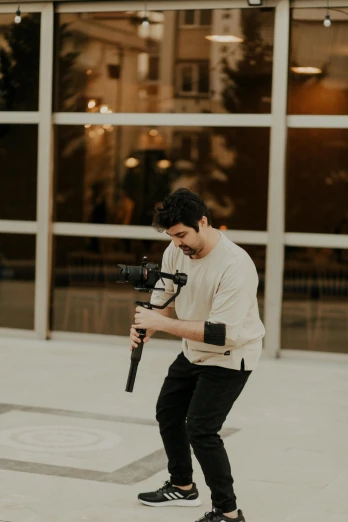 a person is holding a camera near a building
