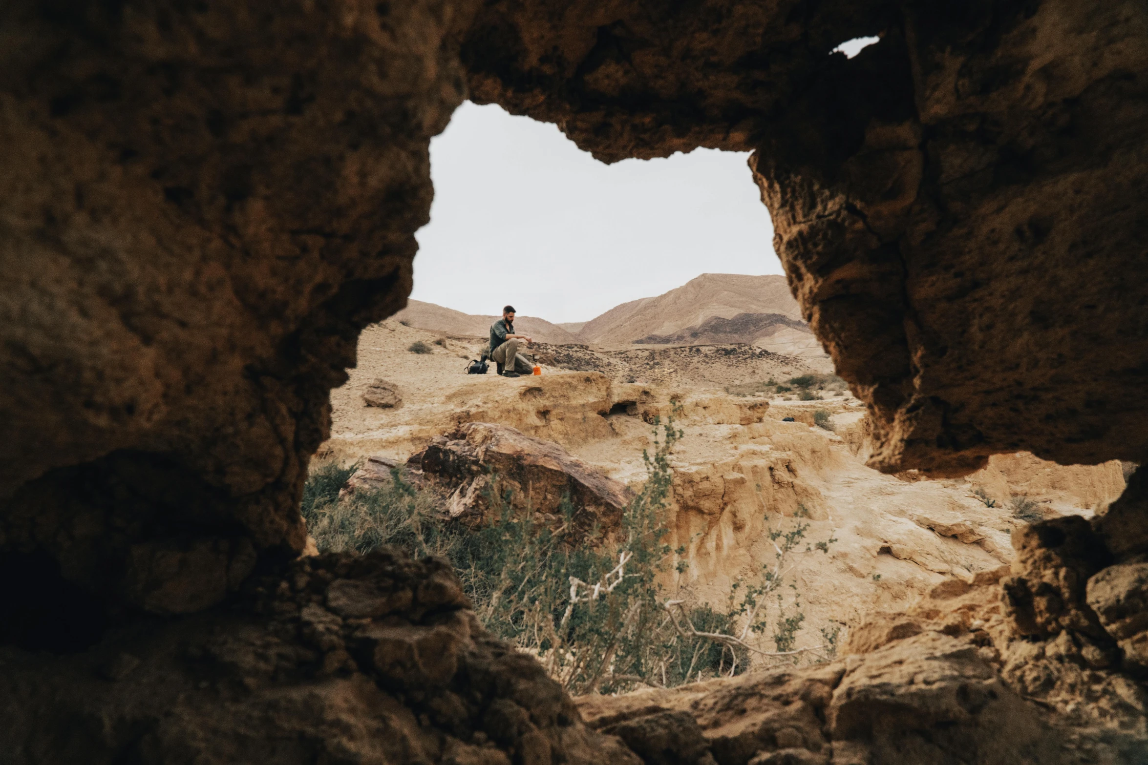 a person riding on a motorcycle through a cave