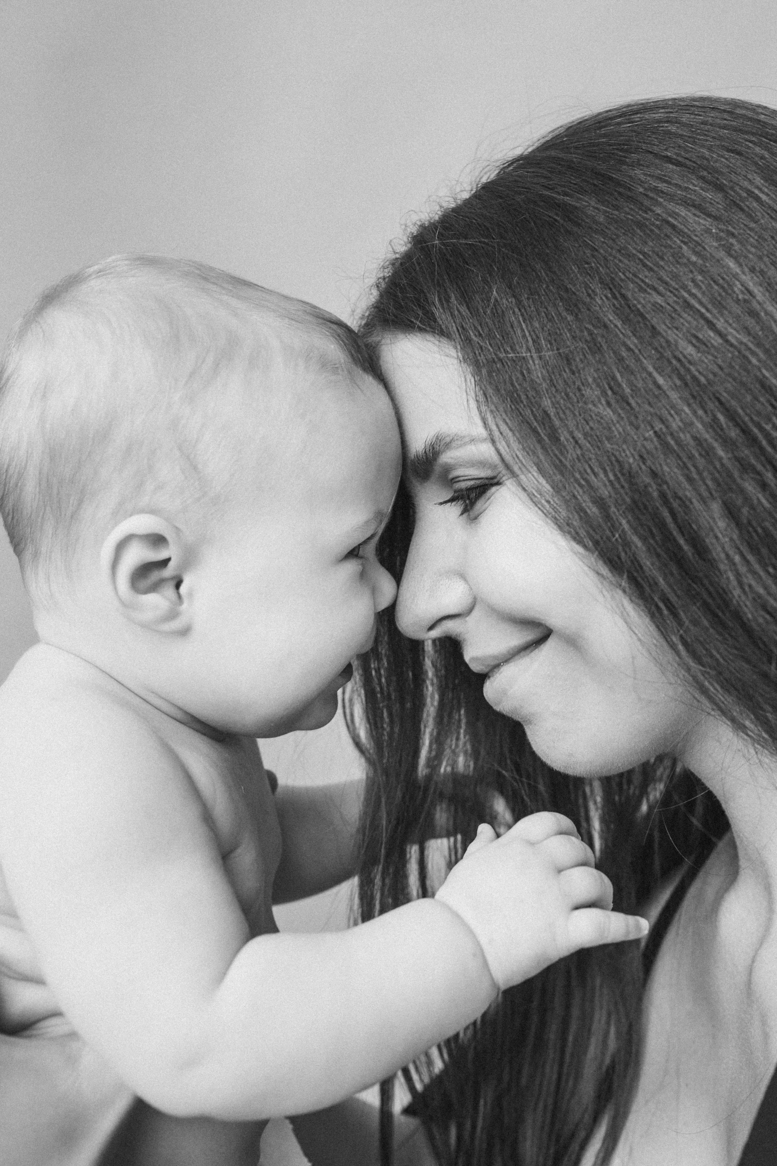 a woman is holding her baby in the air