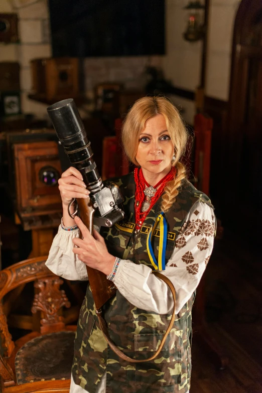 a woman holding a camera up in the air