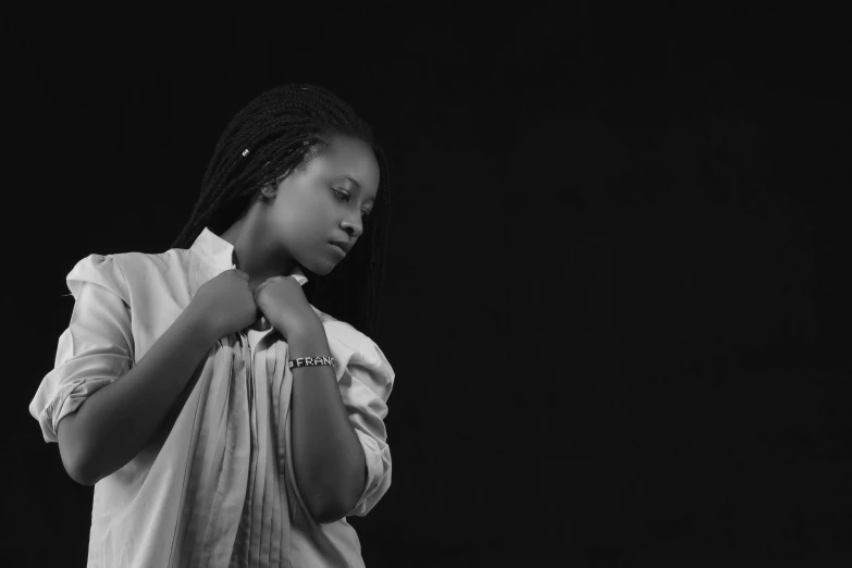 a girl poses for the camera, holding her arms to her chest