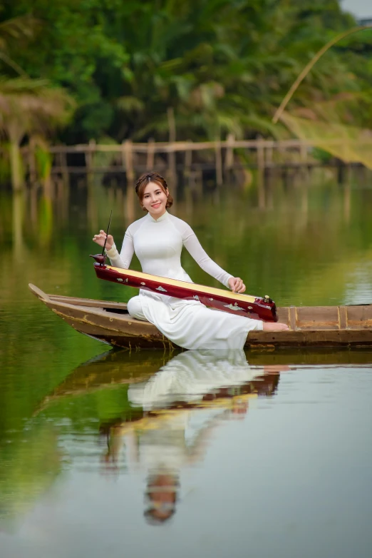 a woman with a hat on sitting in a small boat