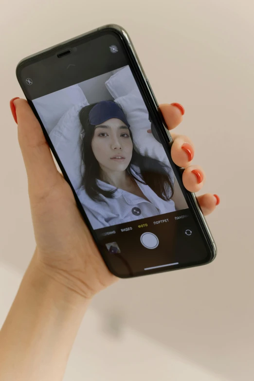 the cell phone is displaying an image of a woman