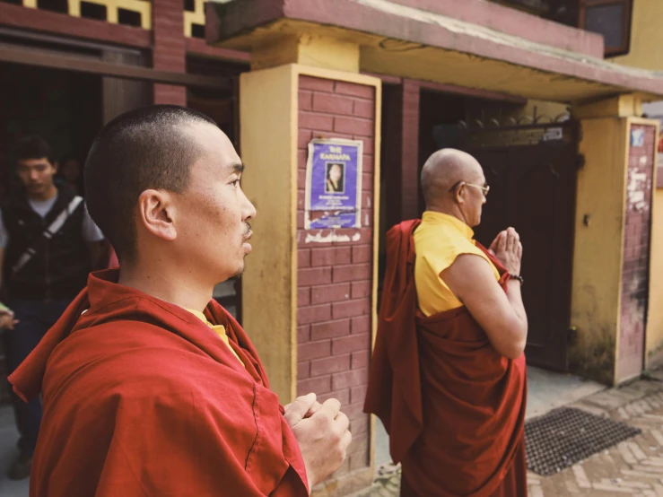 a group of men in red and yellow robes talking