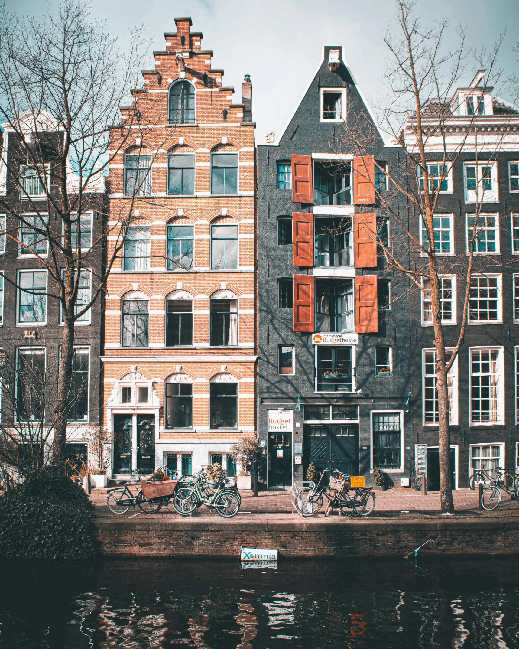 a river running between two tall brick buildings