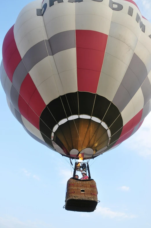 a person on a basket under a large  air balloon