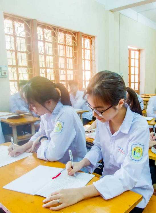 several students are studying in desks at the same time