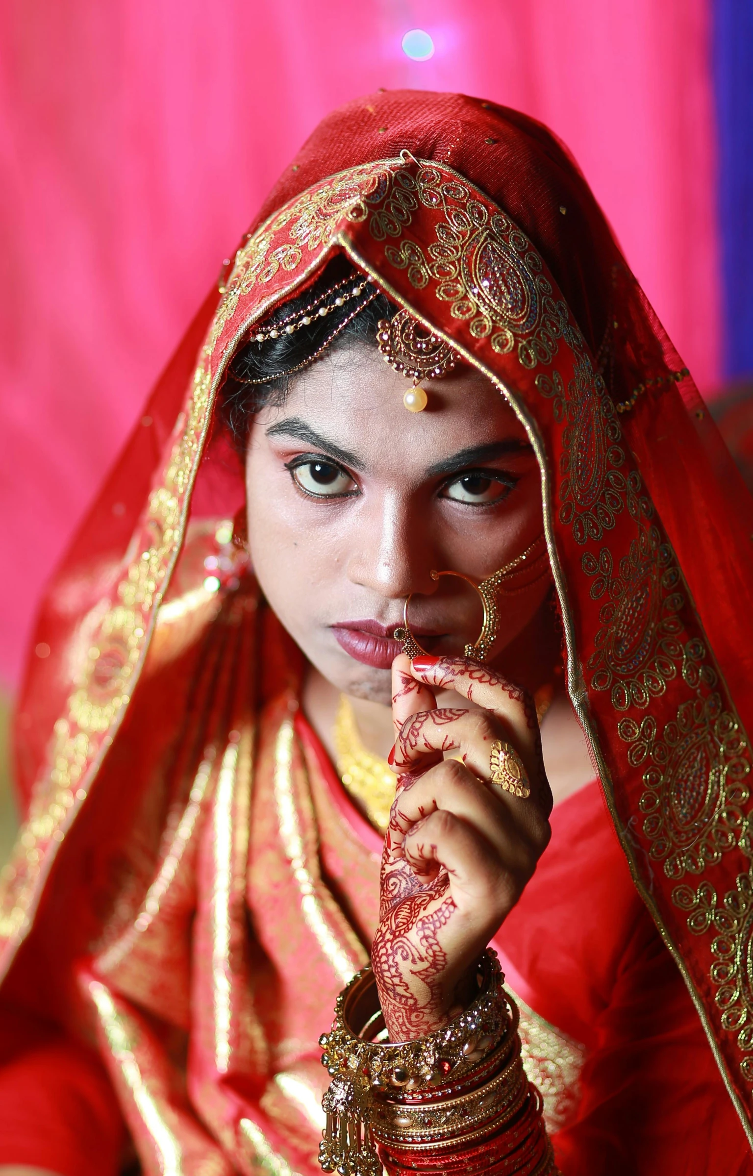 a young woman in a red and gold dress is holding a golden object in her hands