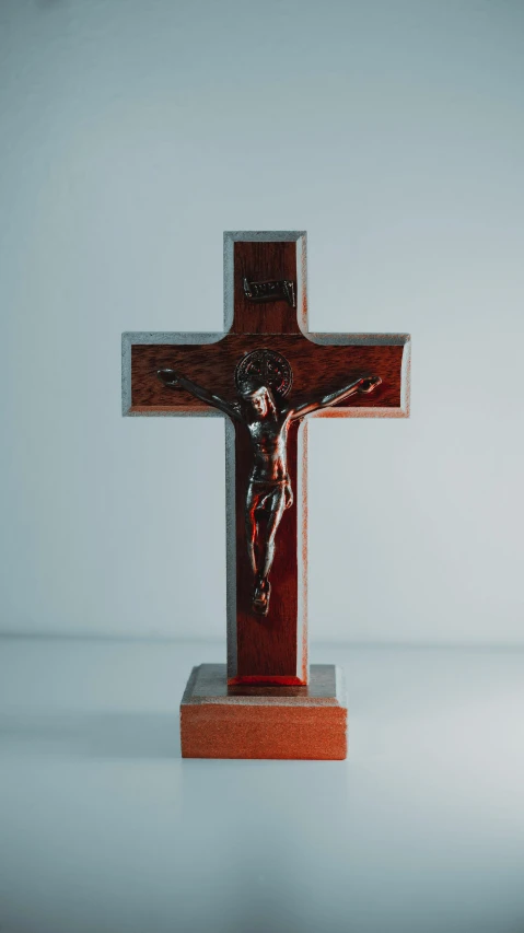 a cross with a person is sitting on it