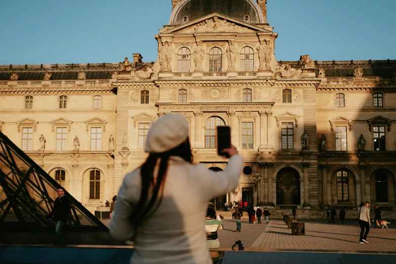 a person is taking a picture in front of a building