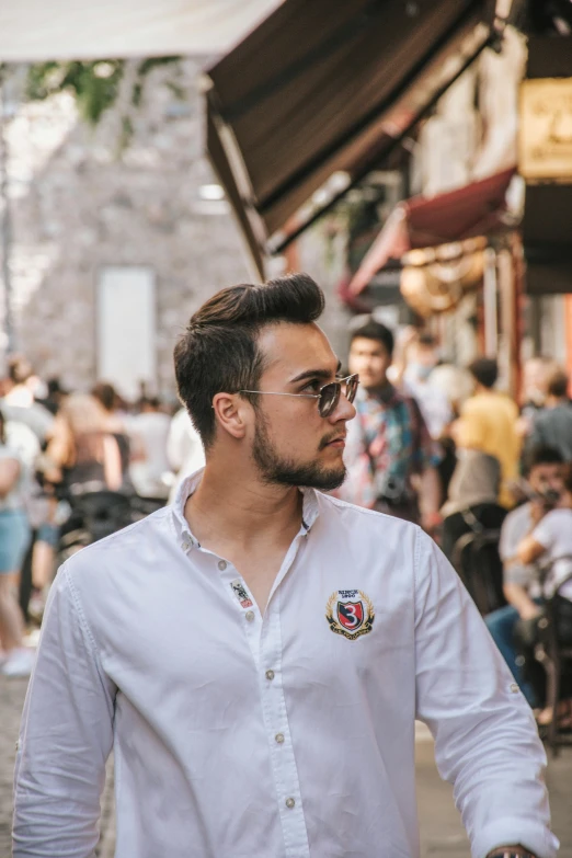 a man standing on the sidewalk in front of a crowd of people