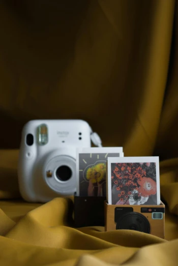 a white camera is near a yellow sheet