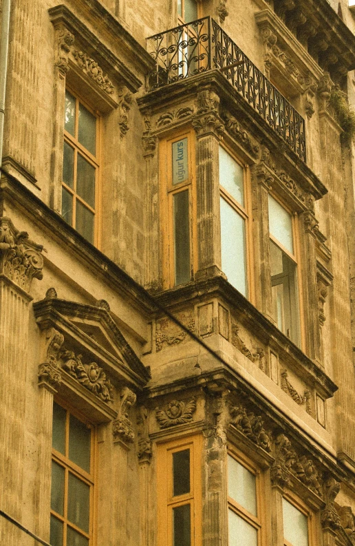 an old, faded po of an apartment building with an ornate balcony