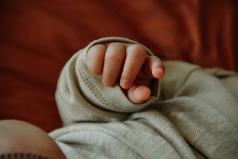 a hand reaching into the air while lying down