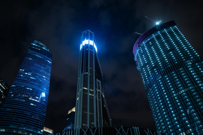 a high rise building with illuminated lights at night