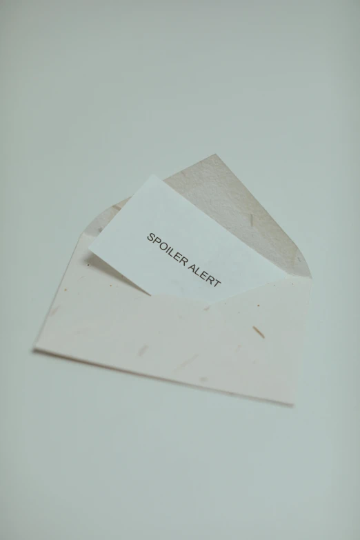 an open envelope with a piece of paper on top