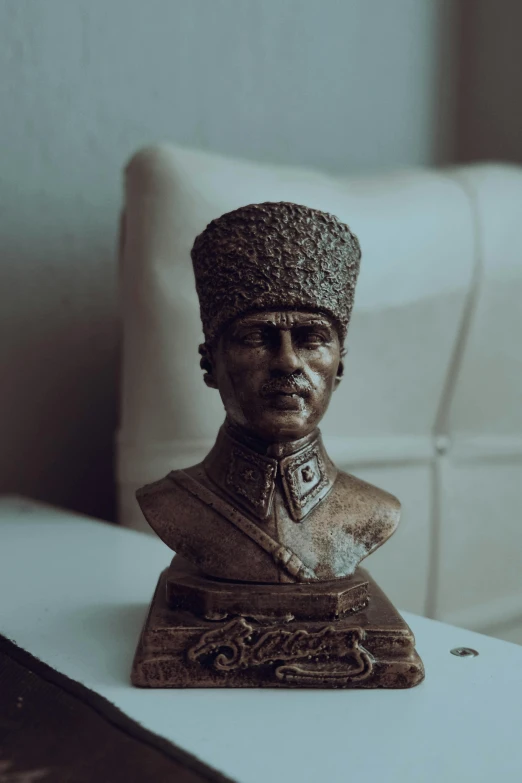 a figurine of a man with a headpiece on a table