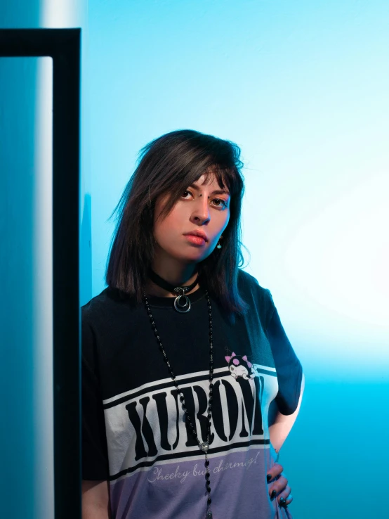 a girl in a black shirt, wearing a chain