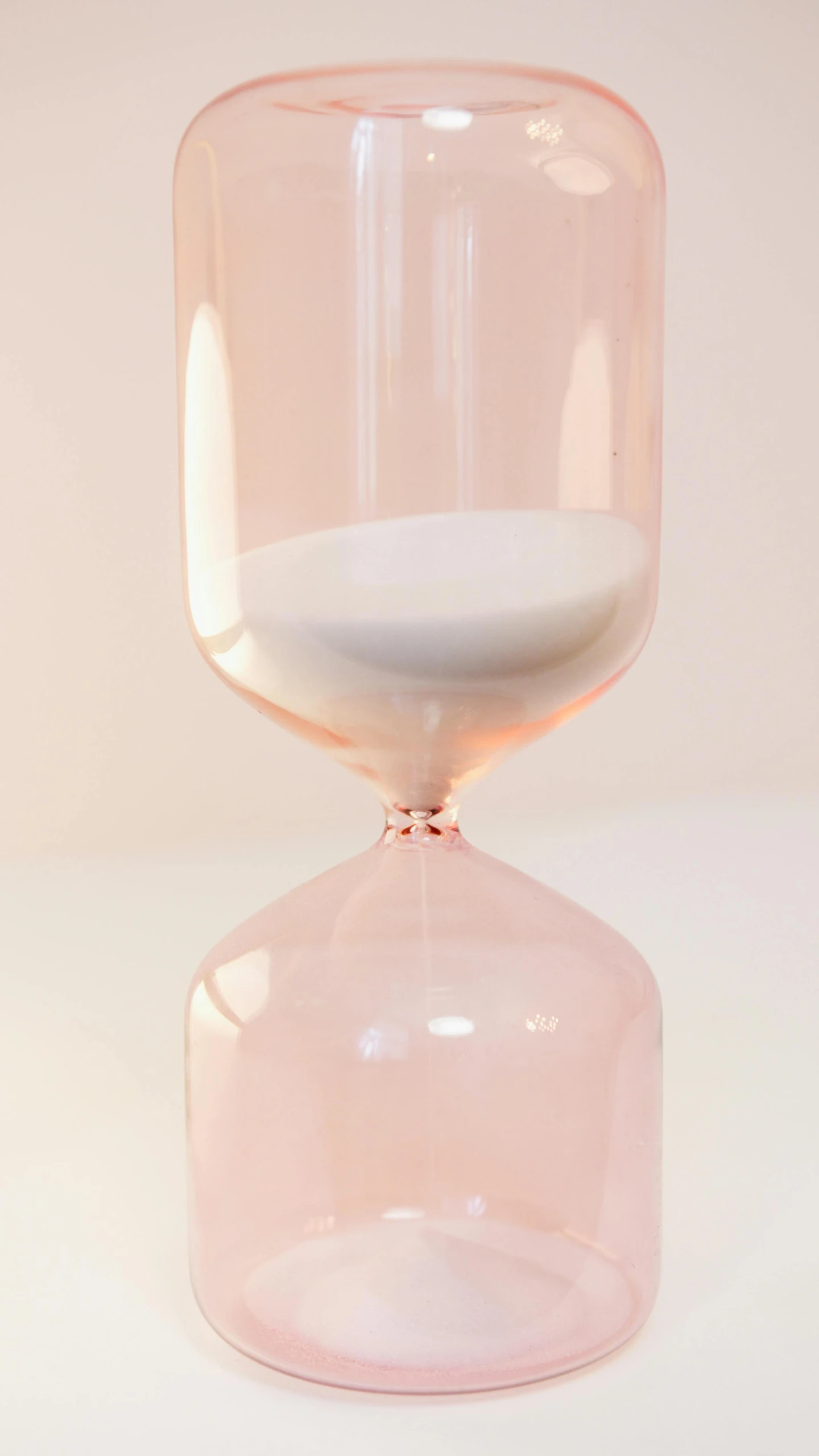 an hourglass is sitting on a white table