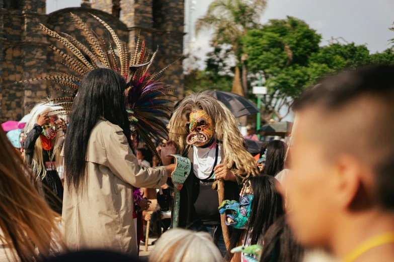 an image of a mexican parade being followed by some women