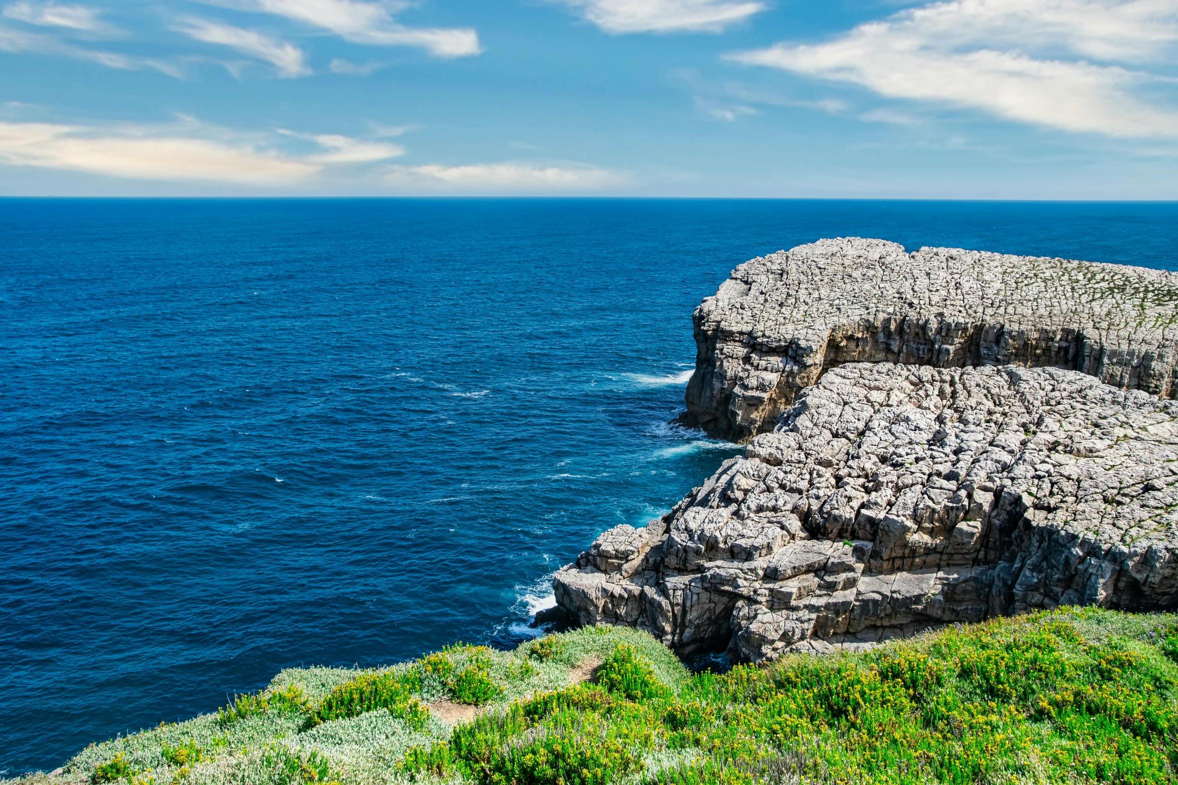 an island with several small rocks near the ocean