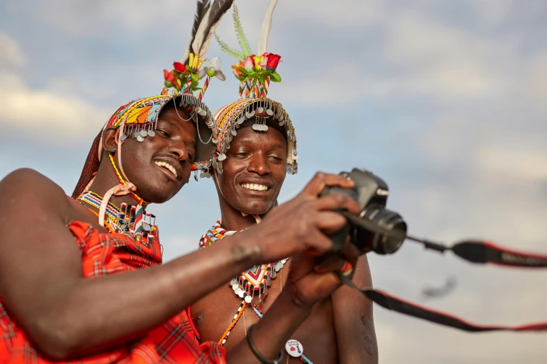 two african american people taking a po with their camera