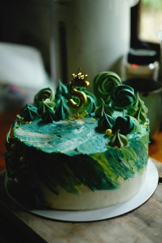 a green cake with chocolate icing and decorations