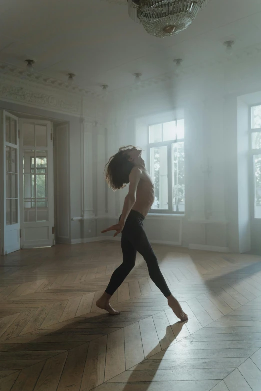 a woman is dancing in a large room