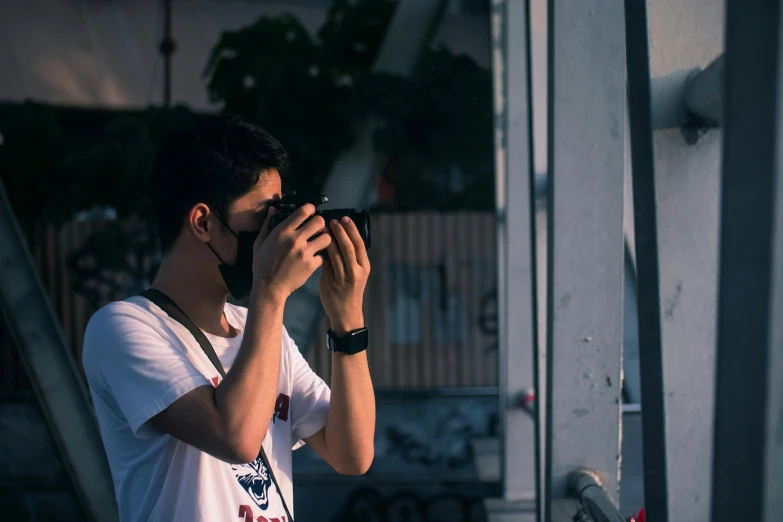 a young man taking a po of himself with a camera