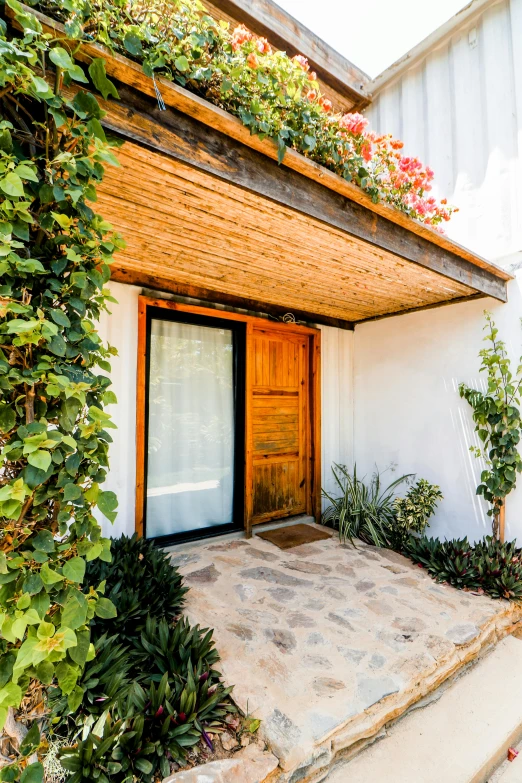 a small building with a porch and steps leading to it