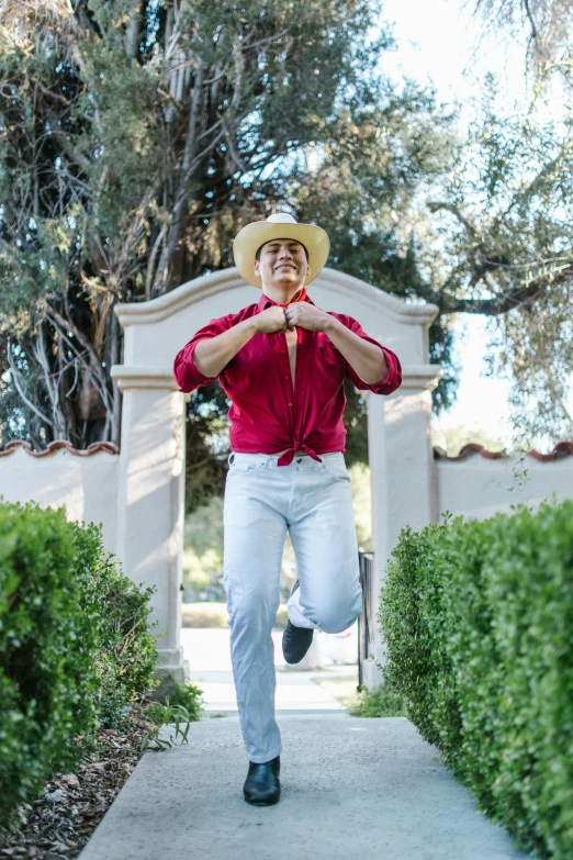 a man is running with a straw hat on