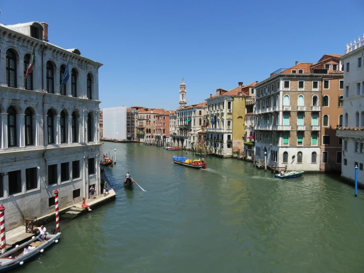 there are many boats on the water by this canal