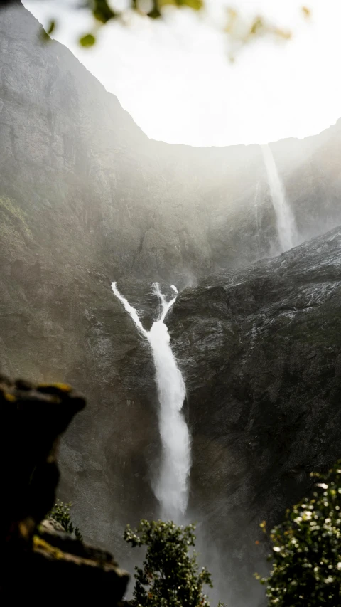 a waterfall is seen flowing into the water