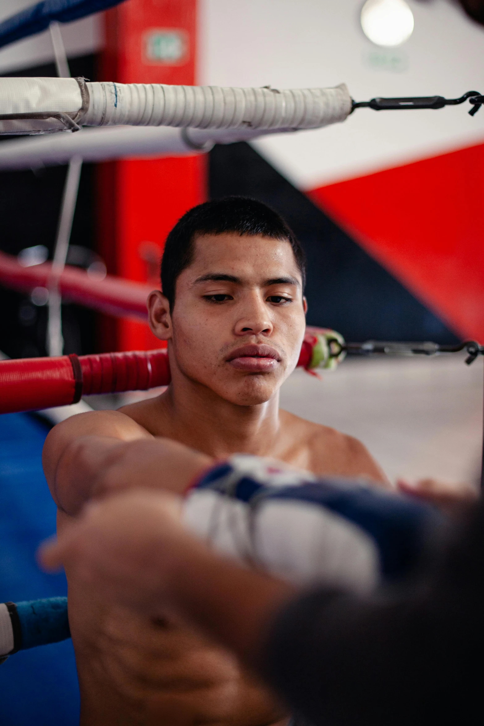 a man standing next to a punching bar