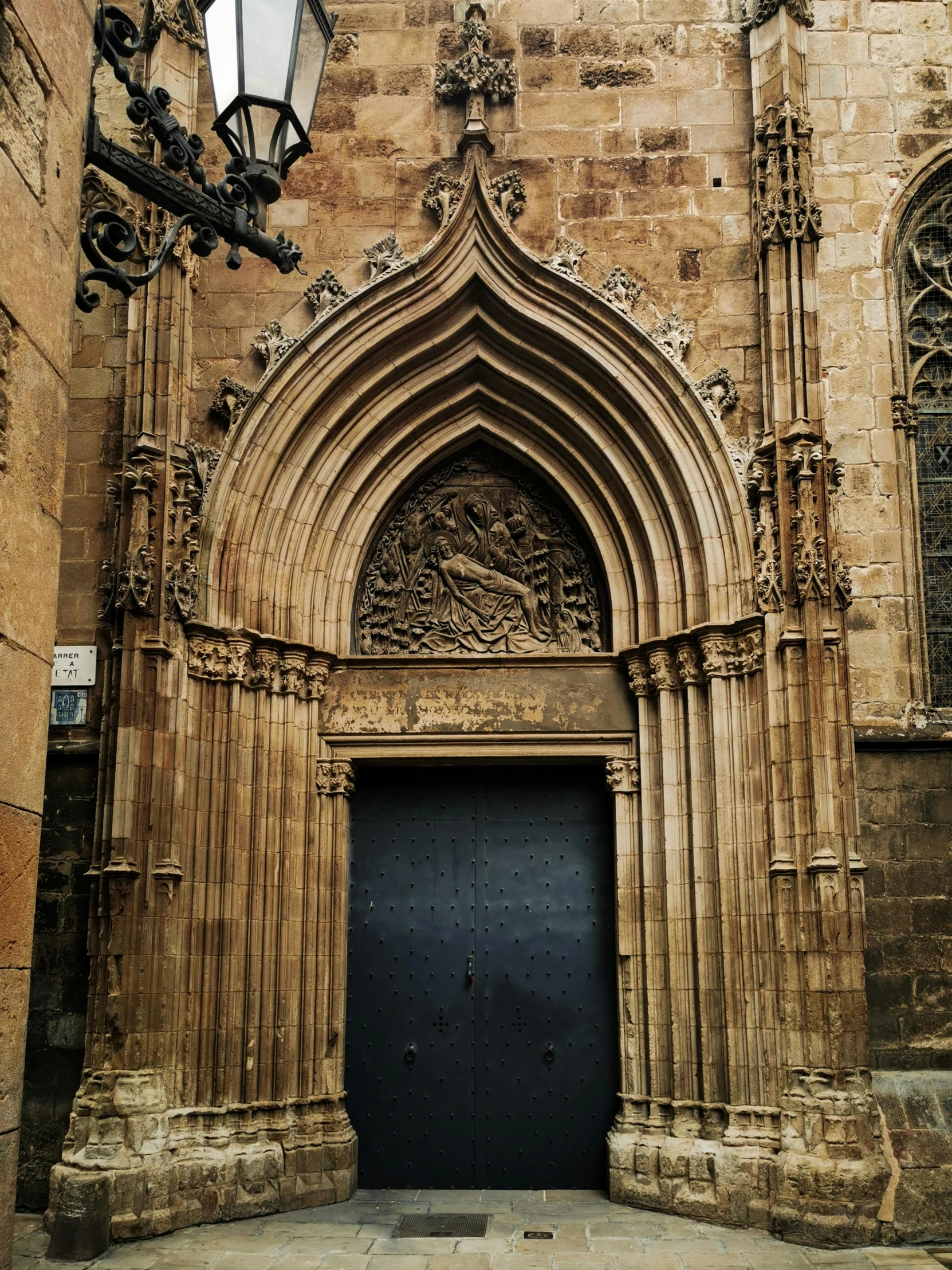 a very large brown building with some stone work