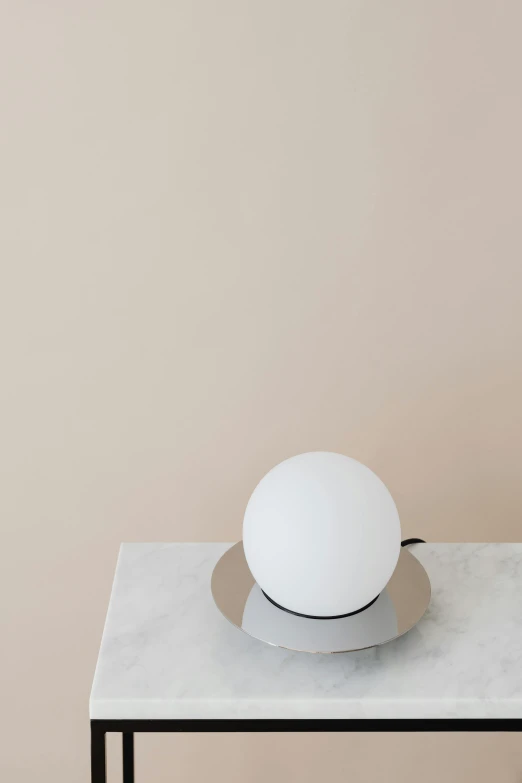 an empty white table on a beige wall