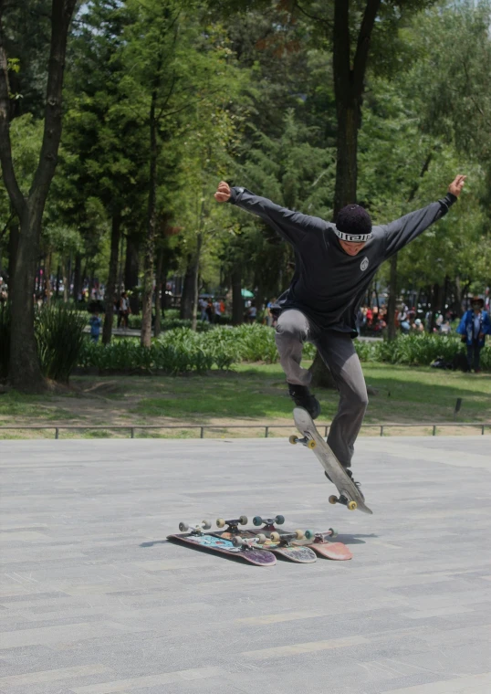 a skateboarder doing a trick in the middle of a park