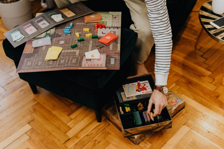 a young child is playing with a small table and game