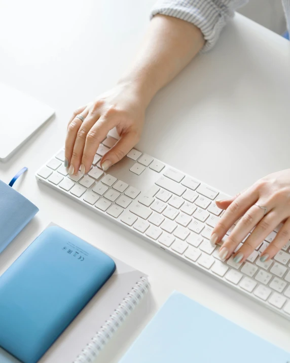 a person holding their hand on the keyboard