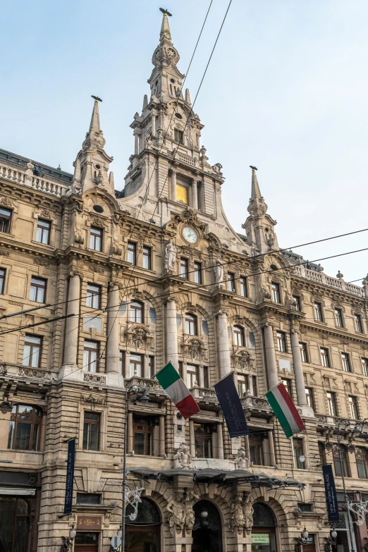 an old building has an elaborate tower structure with flags