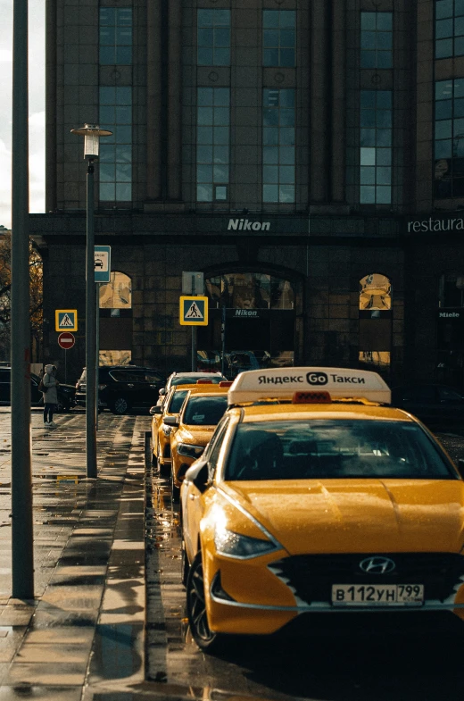 a group of cars parked next to each other in front of buildings