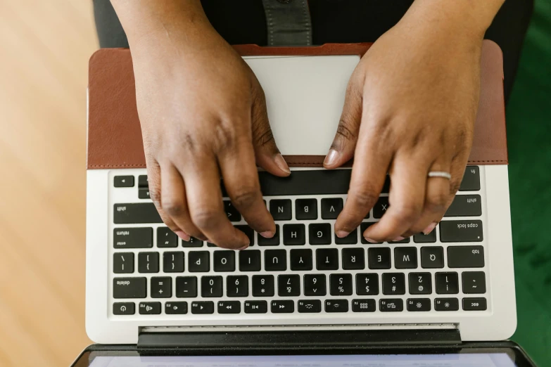 a woman is typing on her laptop keyboard