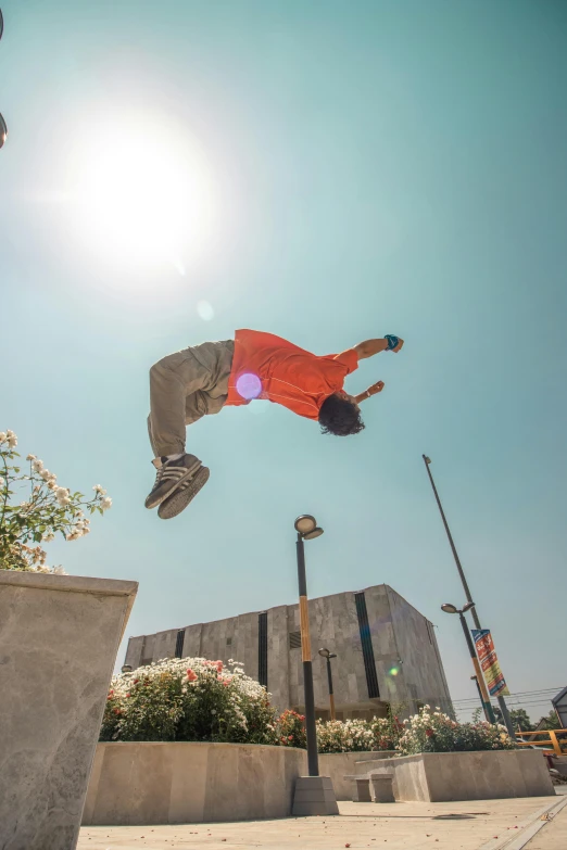 a skateboarder high up in the air, in a city