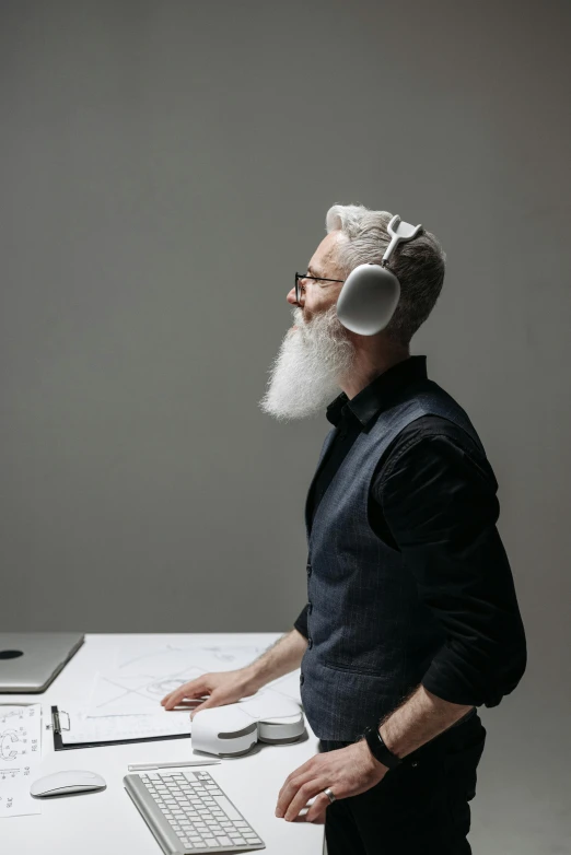 a man with long white beard in front of a computer