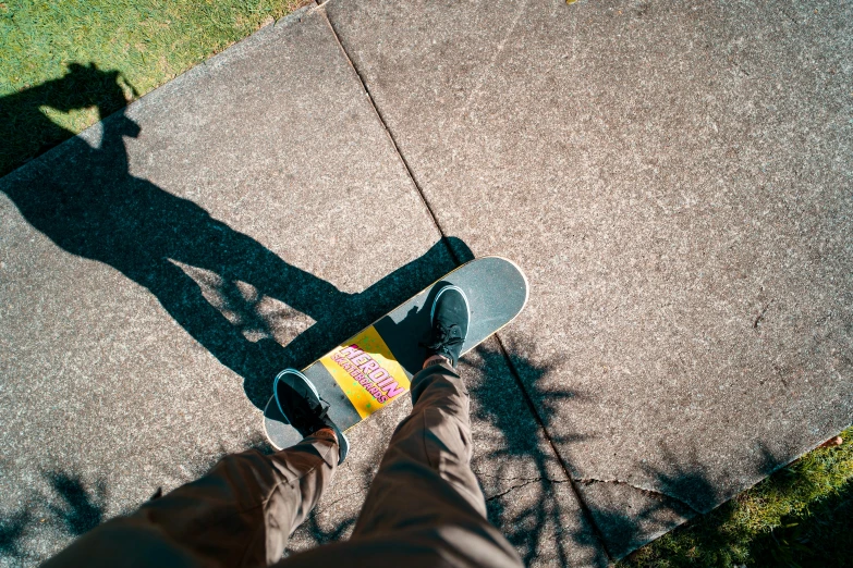 the person is riding on their skateboard down the street