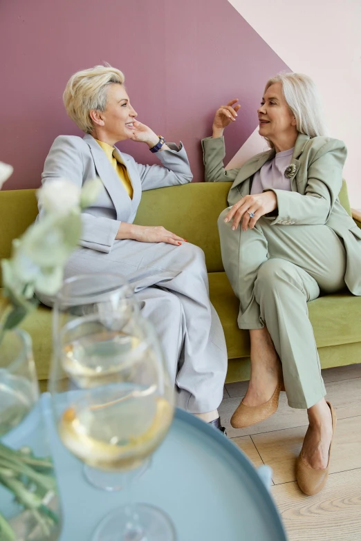 the two women sit next to each other and talk